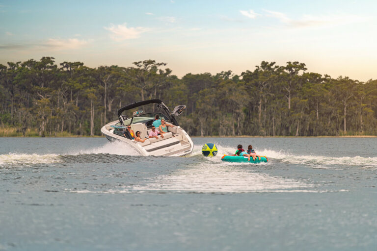 Friends tubing behind an SDX 270 Surf